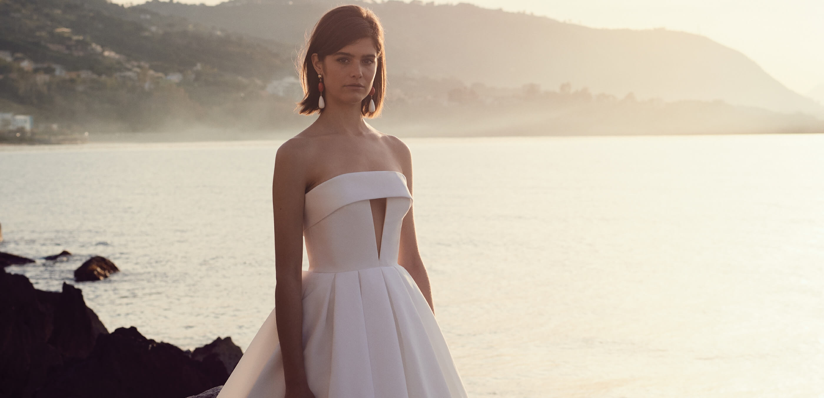 Model wearing a white evening dress - Desktop Image